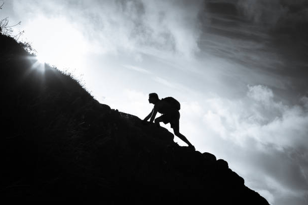 Man scrambling up a gentle incline