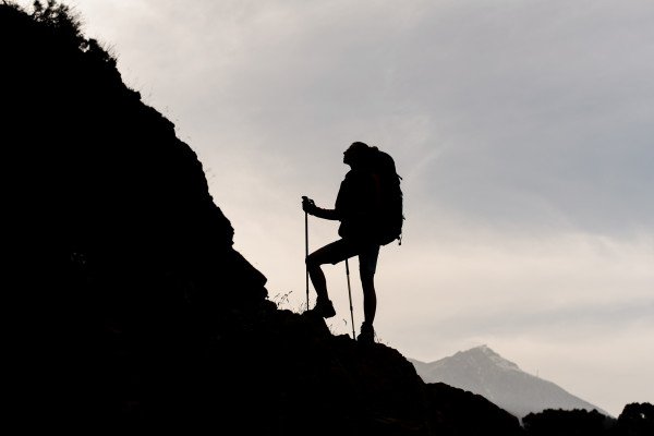 Woman hiking up a steep hill